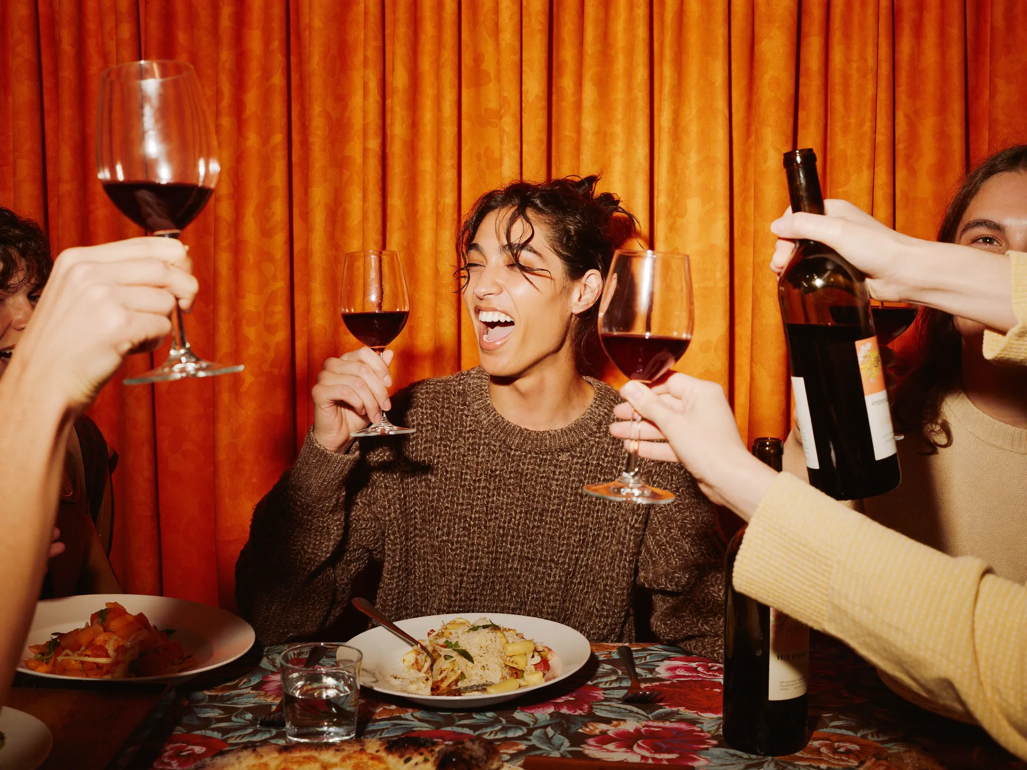 Friends sharing food and drinks at a local spot