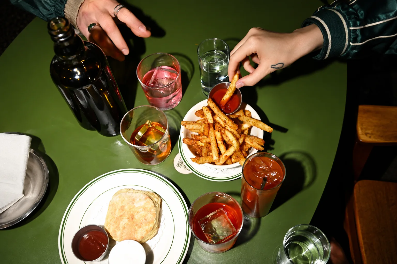 Friends sharing food and drinks at a local spot